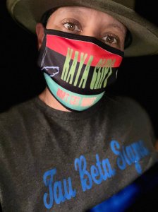 Tau Beta Sigma is emblazoned across the chest of a Somesha Adams, who is also wearing a mask from a company that she created, "Kaya Clips."